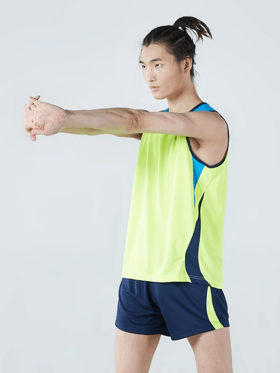 Man stretching in Men's Athletic Mesh Tank Top and Shorts, neon green and blue, perfect for running and gym workouts.
