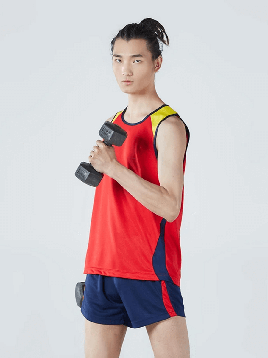 Man in red athletic mesh tank top and shorts holding a dumbbell, perfect for gym workouts and running. Lightweight and breathable.