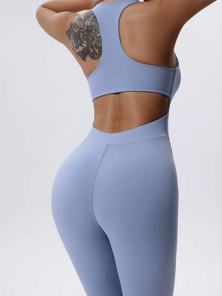 Back view of a blue sleeveless zip-front fitness jumpsuit, showcasing seamless design and supportive fit for gym to street style.