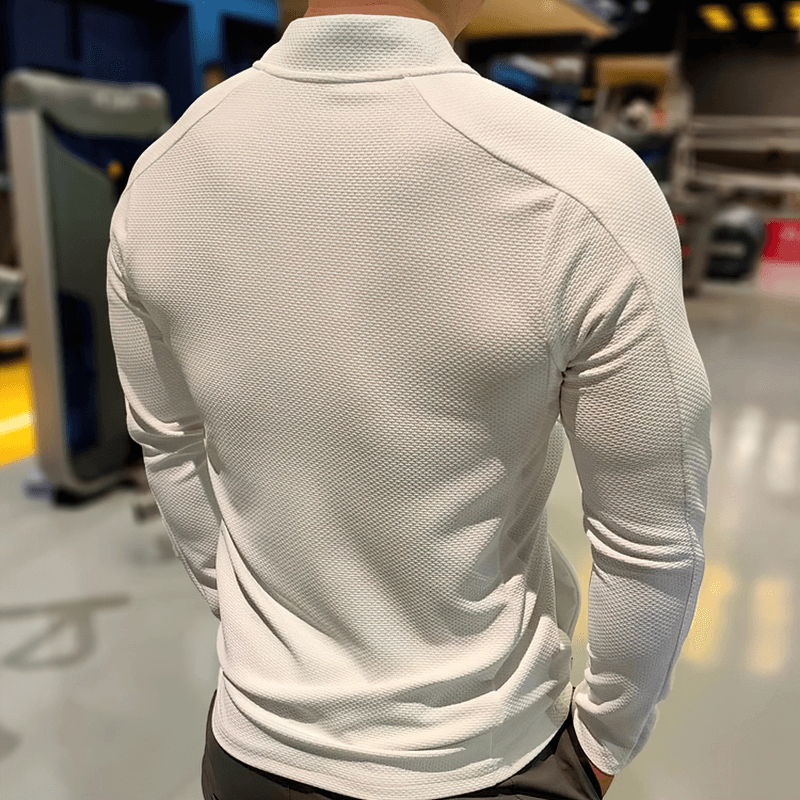 Back view of a modern textured zip-up sports jacket in white, featuring breathable fabric, ideal for running and outdoor activities.