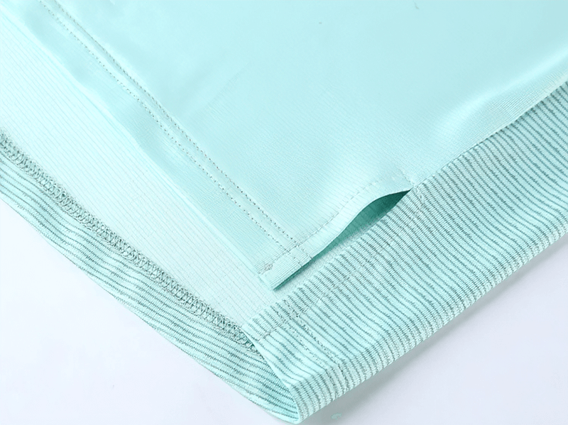 Close-up of a light blue moisture-wicking athletic t-shirt fabric and hem detail, perfect for active men's fitness wear.