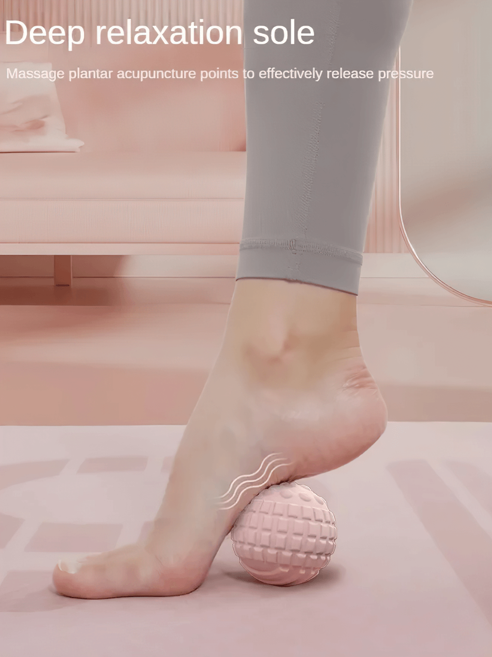 Foot using a multi-color massage ball for muscle relief and relaxation on a pink surface.