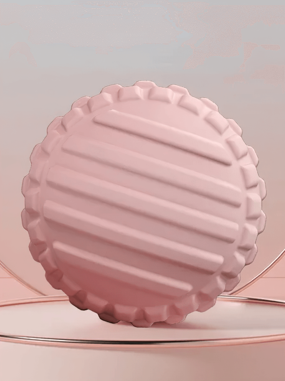 Pink grooved massage ball for muscle relief, relaxation, and improved circulation with textured design.