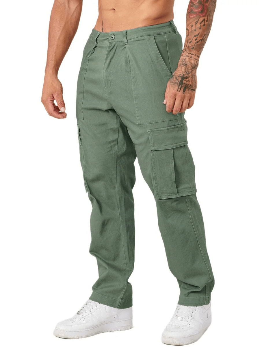 Man wearing green multi-pocket training cargo trousers SF1921 for active wear, showcasing comfort and style with white sneakers.
