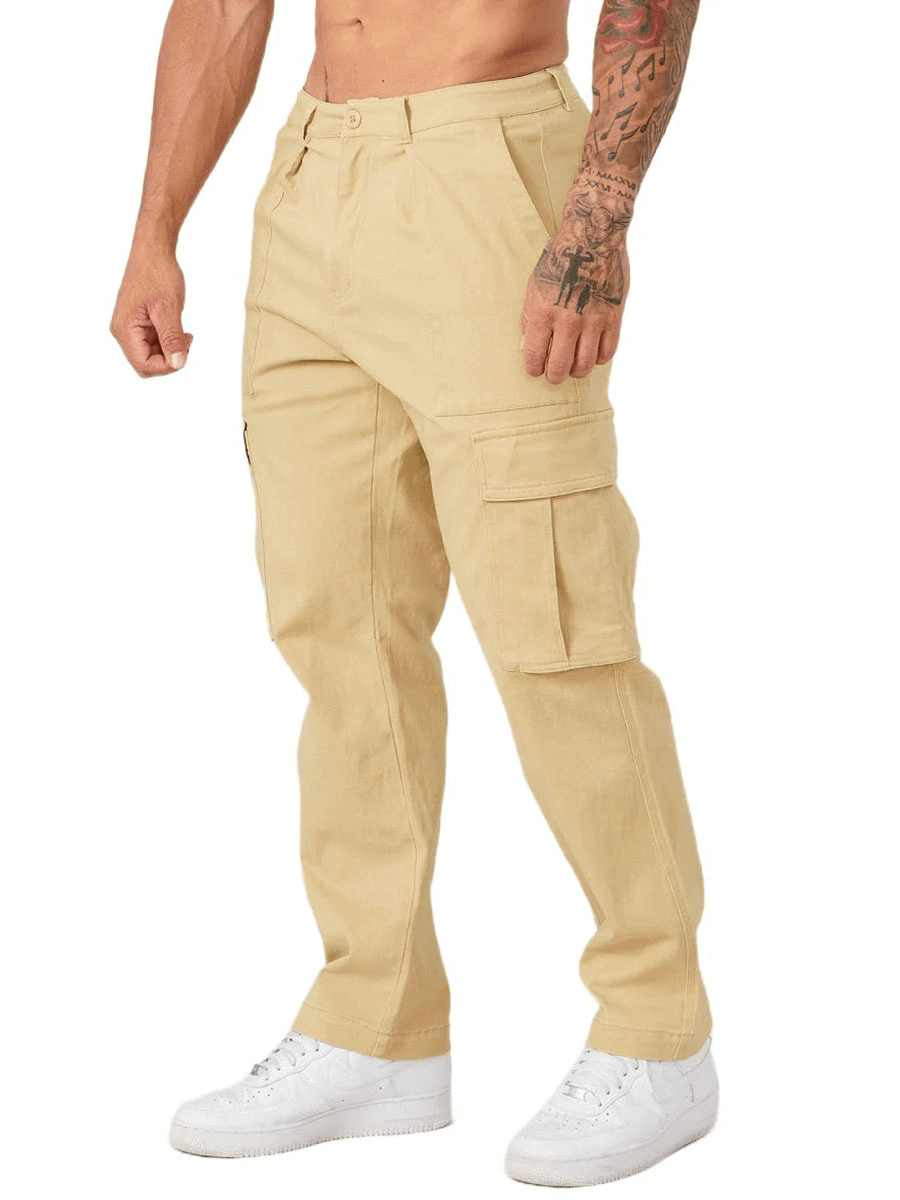Man wearing beige multi-pocket training cargo trousers with white sneakers, showcasing the comfort and storage features.