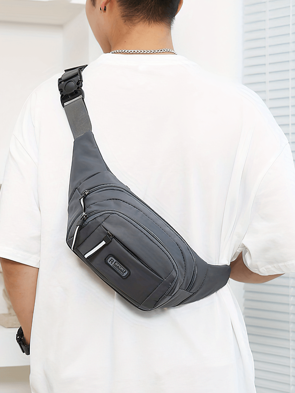 Outdoor enthusiast wearing a gray multi-pocket waist bag SF2680 with adjustable strap, ideal for travel and sports storage.