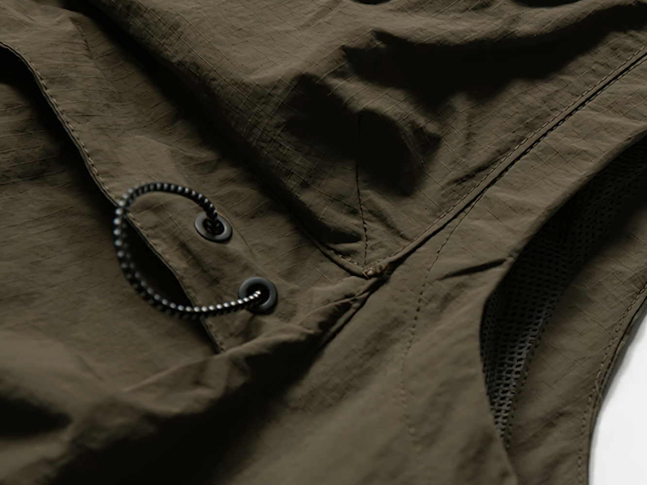 Close-up of waterproof cargo vest SF2279 in nylon with hood, showcasing durable fabric and drawstring detail for outdoor use.