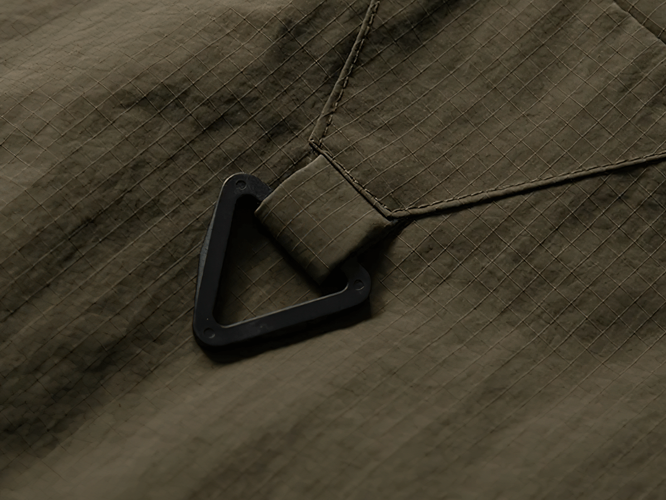 Close-up of waterproof nylon cargo vest fabric and attachment hook