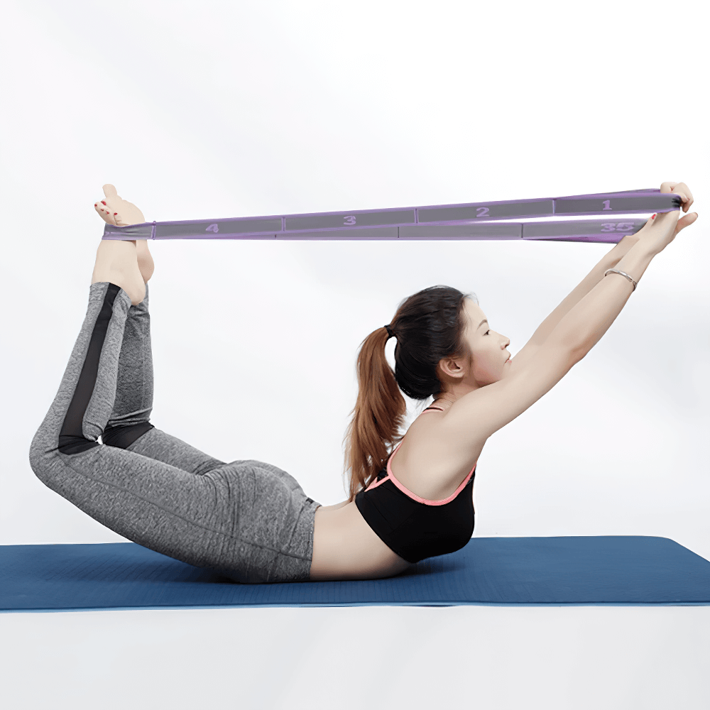 Person using a purple 8-loop yoga stretch strap for Pilates on a blue mat, demonstrating flexibility and balance in a workout pose.