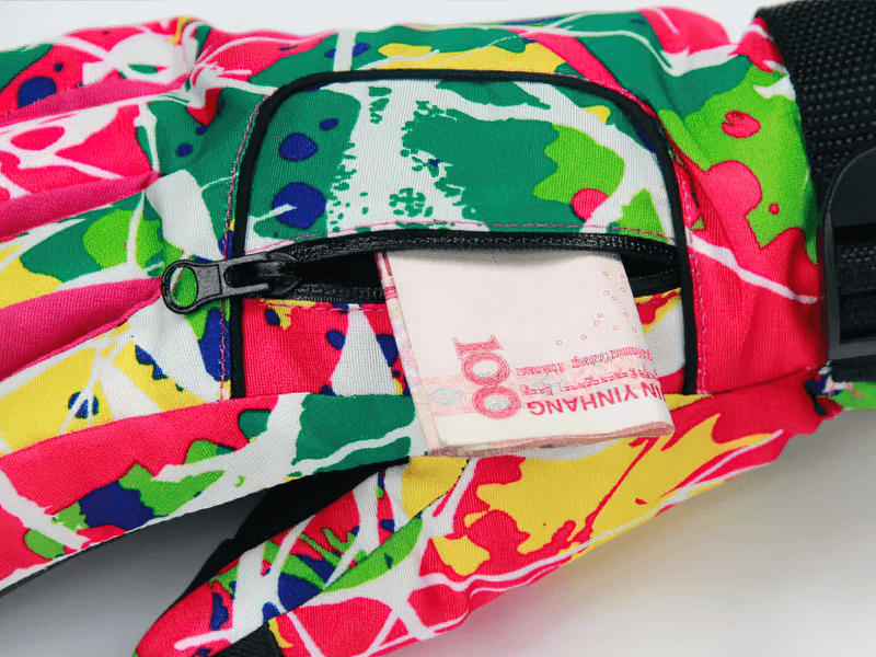 Colorful ski gloves with zip pocket revealing currency, ideal for warmth and storage on the slopes. Multicolor, waterproof, polyester.