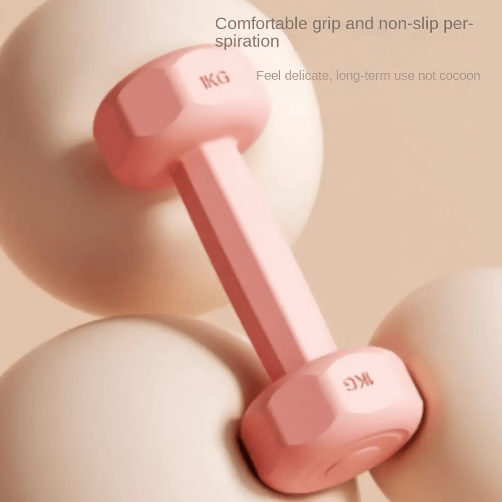 Pink neoprene hex dumbbell with comfy grip for home or gym, resting on smooth surface. Ideal for strength training.