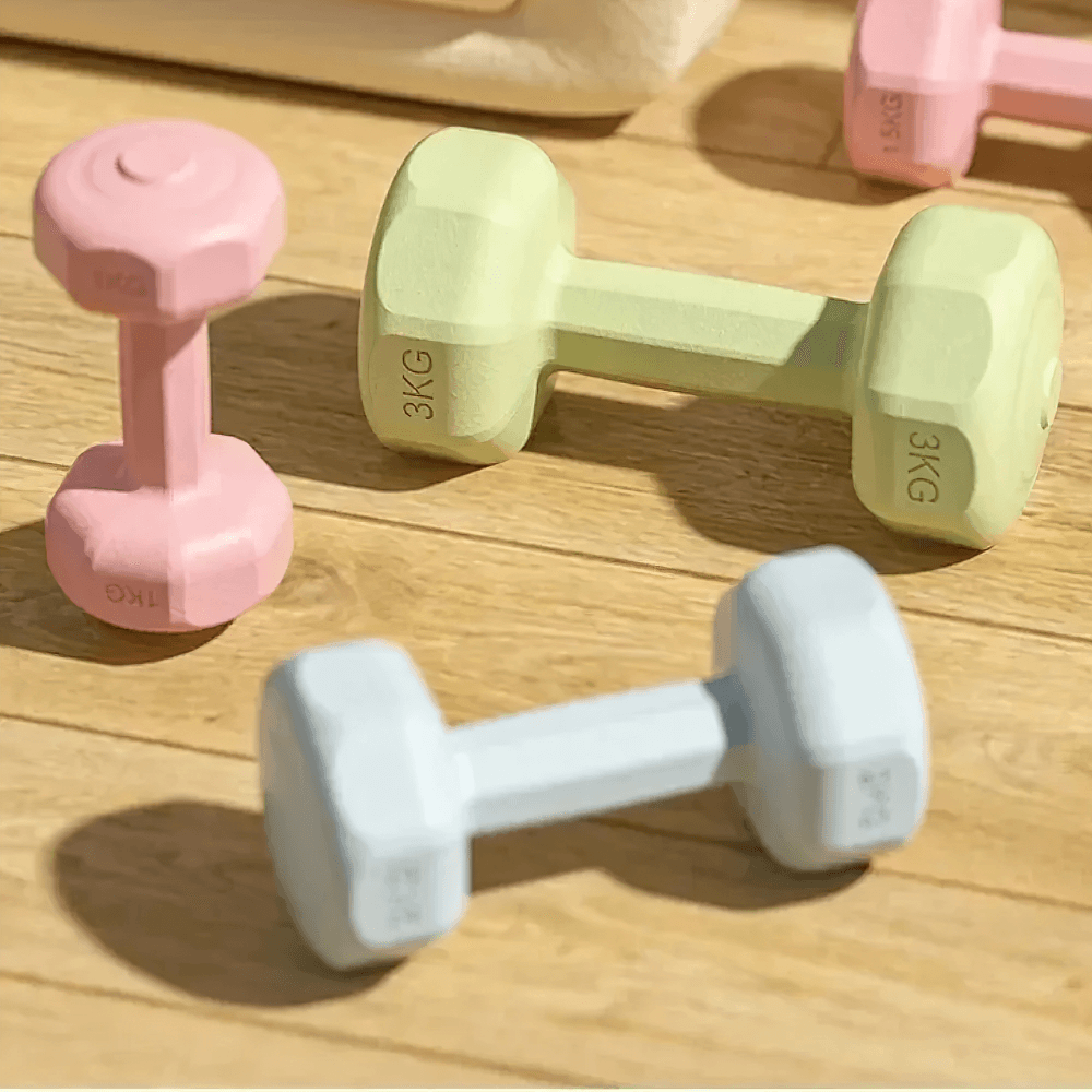 Vibrant neoprene-coated hex dumbbells on wooden floor, perfect for home and gym strength training. Slip-resistant and stylish.