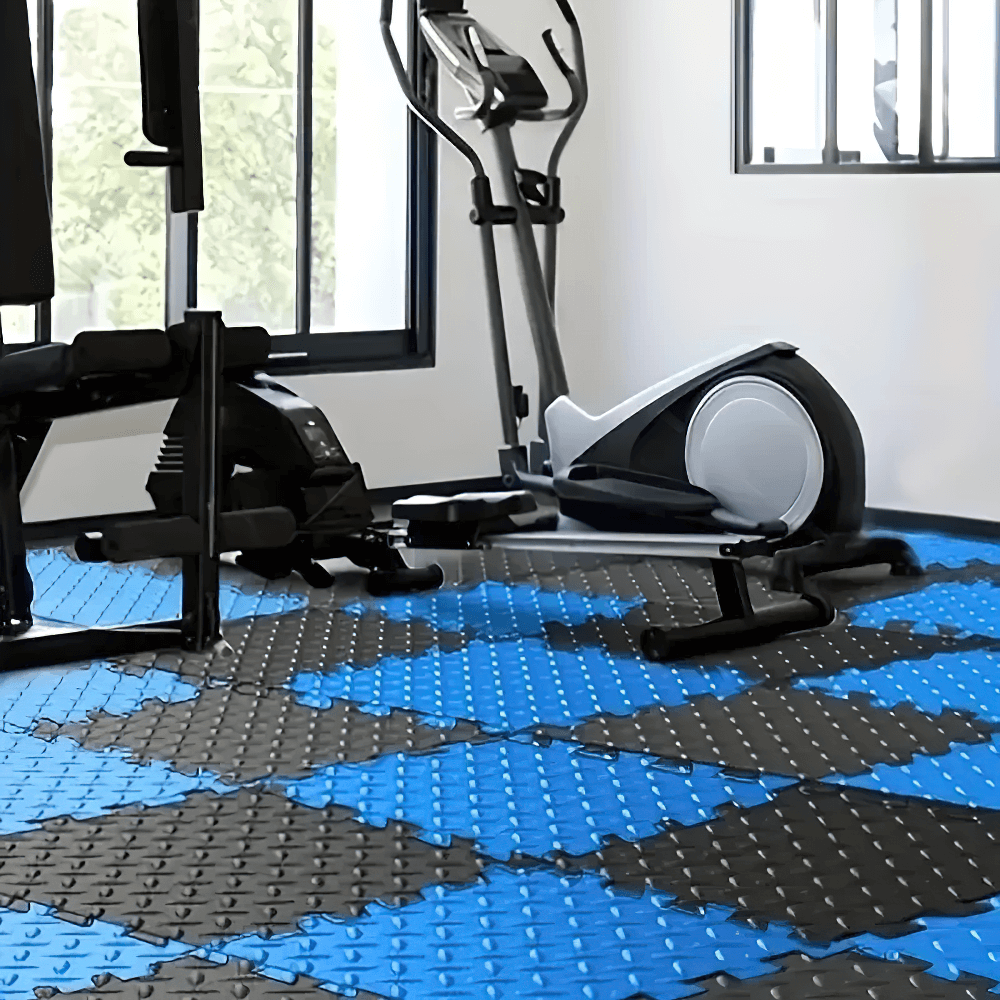 Gym setup on Non-Slip EVA Puzzle Mats for Workout Floors - SF3479, featuring exercise equipment on blue and black interlocking tiles.