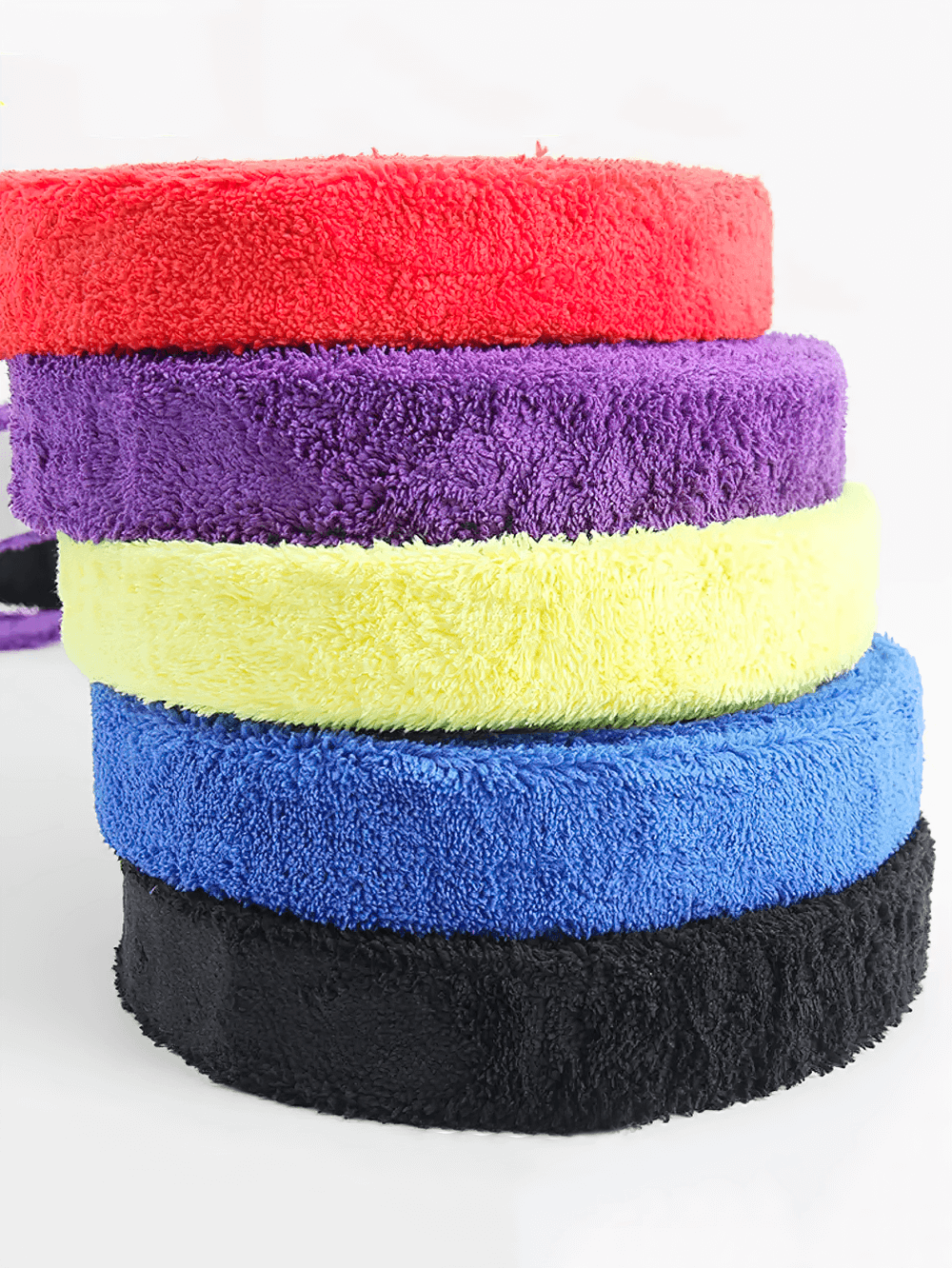 Stack of colorful Non-Slip Racket Grip Tape for Tennis and Badminton - SF3446, featuring durable and sweat-absorbing fabric.