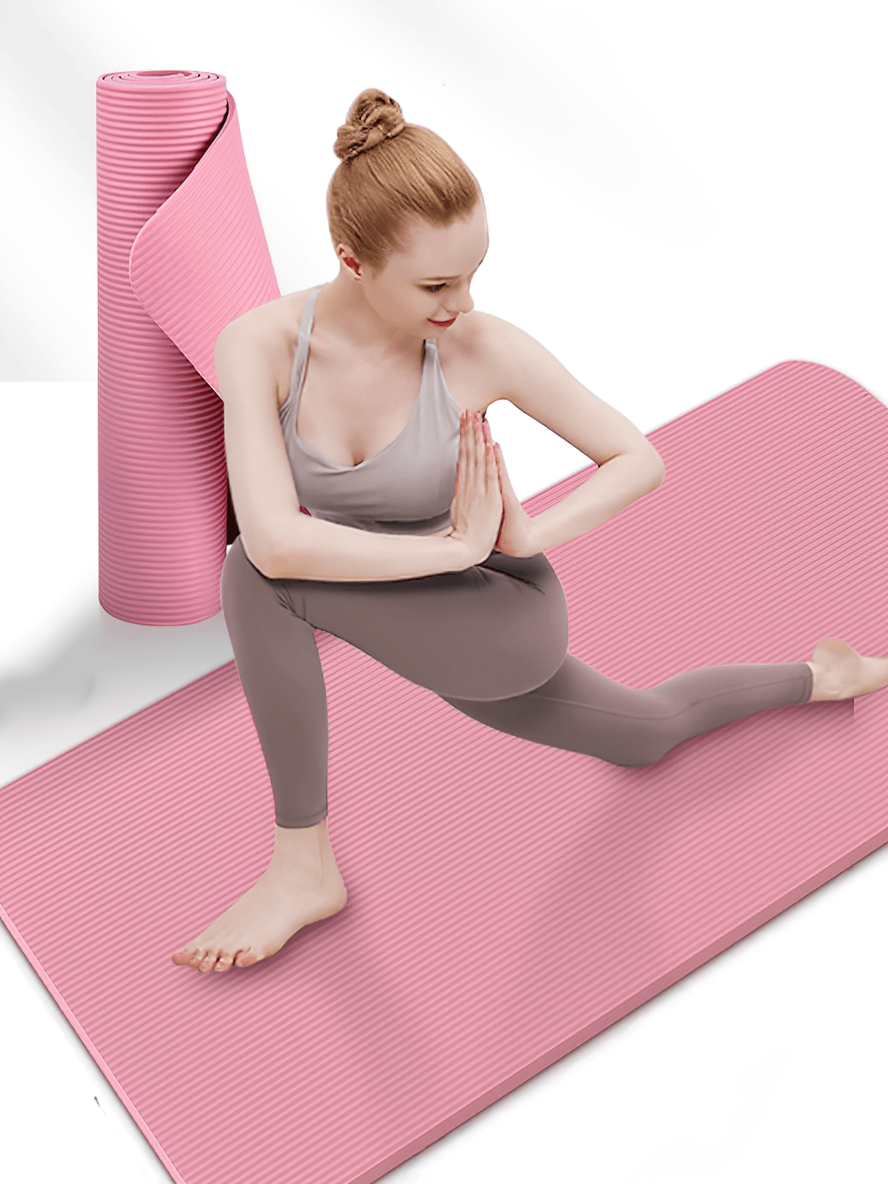 Woman practicing yoga on a pink non-slip mat, ideal for Pilates and home workouts.