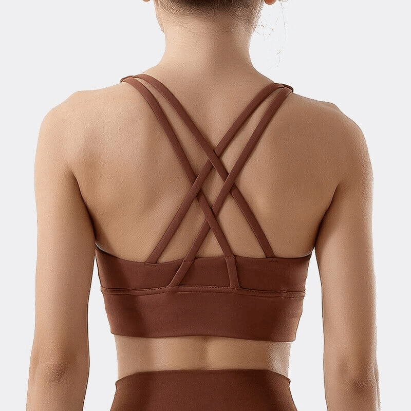 Back view of brown nylon sports top with cross shoulder straps, perfect fit for fitness activities like yoga and gym.