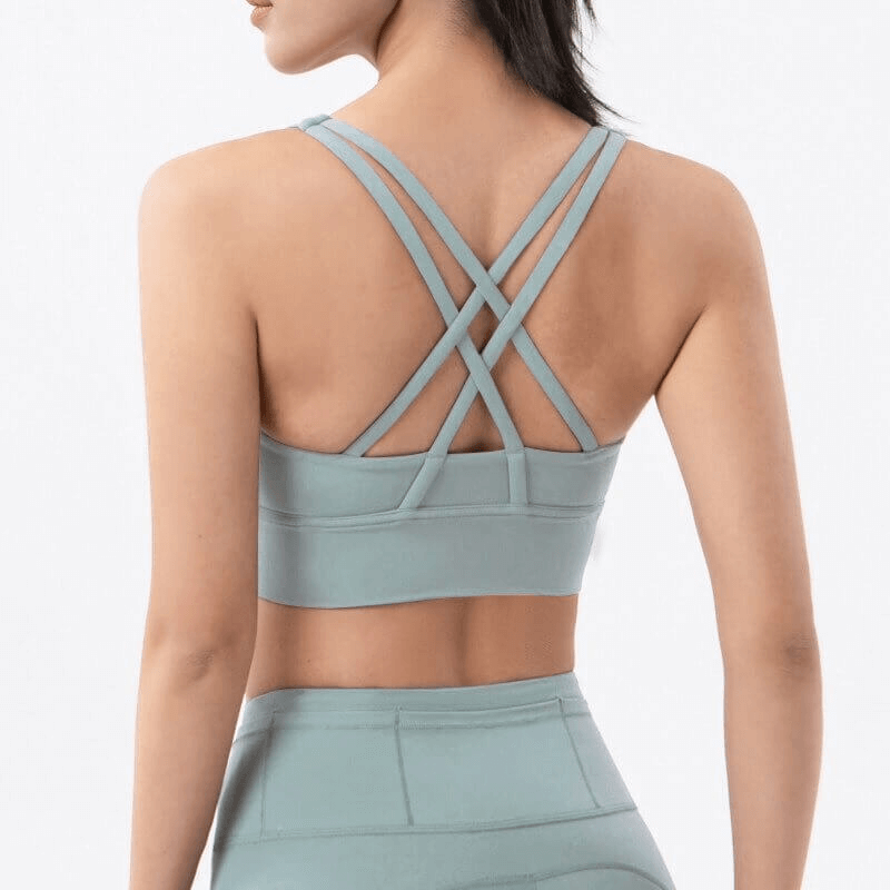 Women's nylon sports top with cross shoulder straps back, perfect for yoga and fitness. Stylish and breathable design.