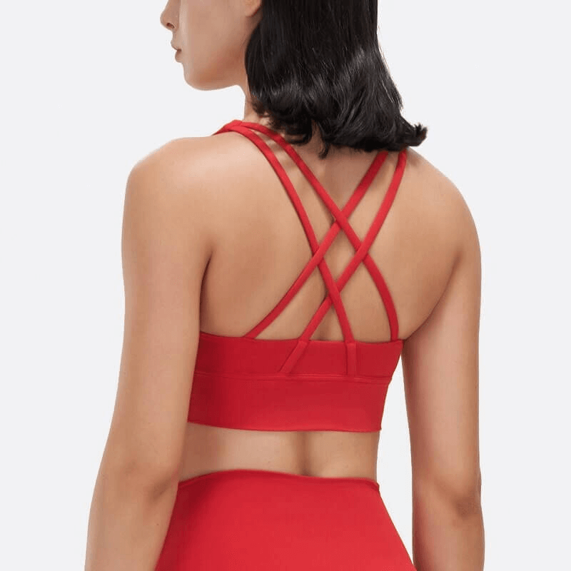 Woman wearing red nylon sports top with cross-shoulder straps back, perfect for yoga and gym, showcasing stylish fitness bra SF0036.