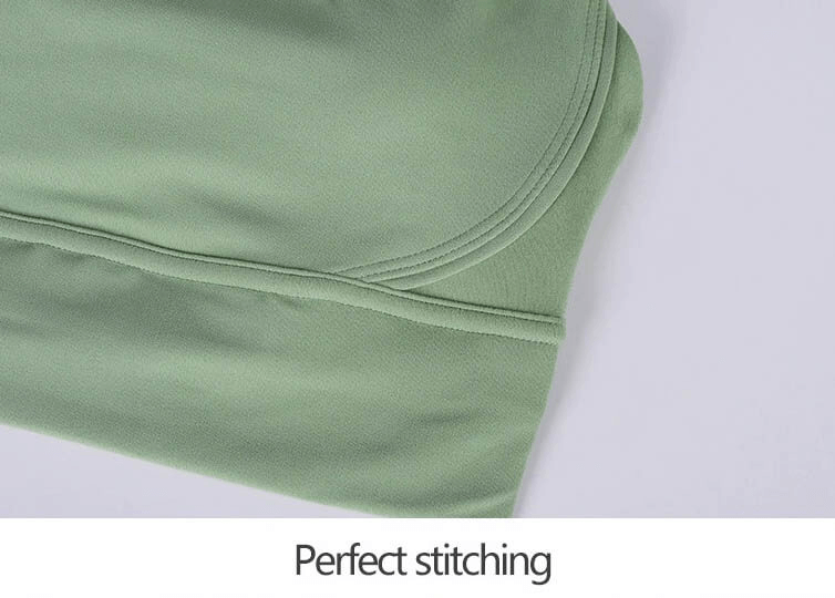 Close-up of green nylon sports top showcasing perfect stitching details.