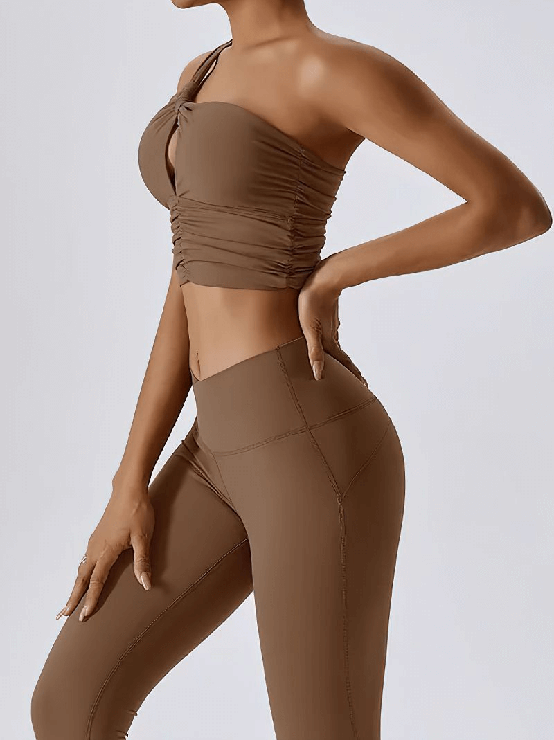 Woman wearing one shoulder backless fitness yoga sports bra in brown, showcasing a stylish, breathable design for active women.