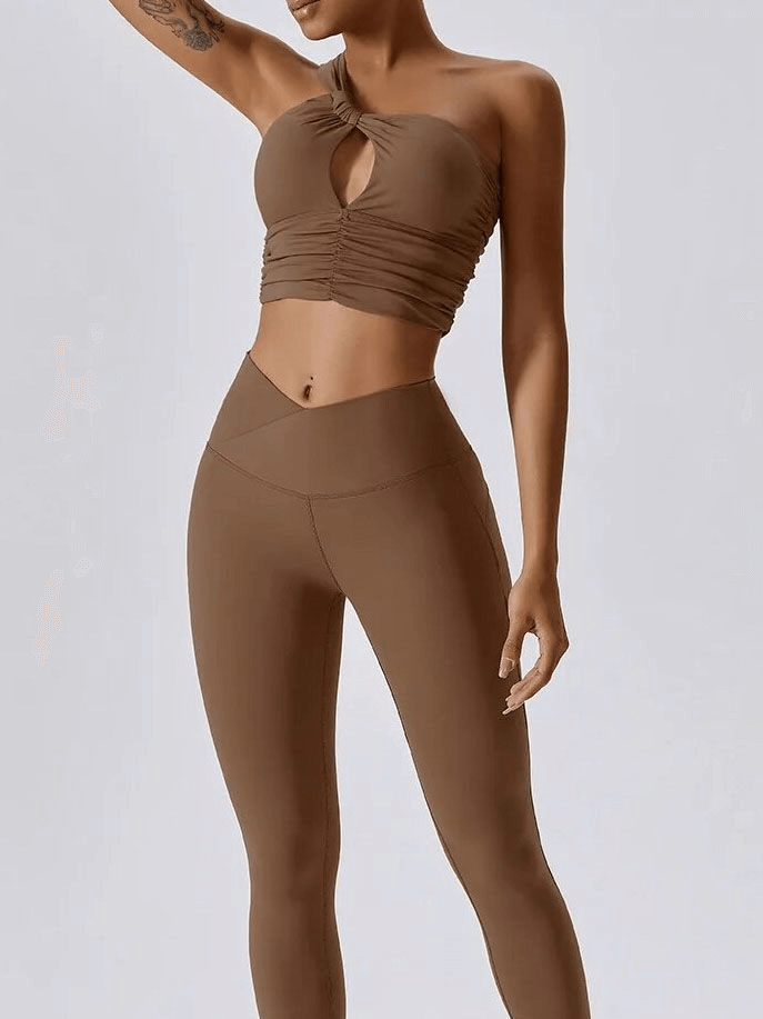 Woman in brown one shoulder backless yoga sports bra and leggings set