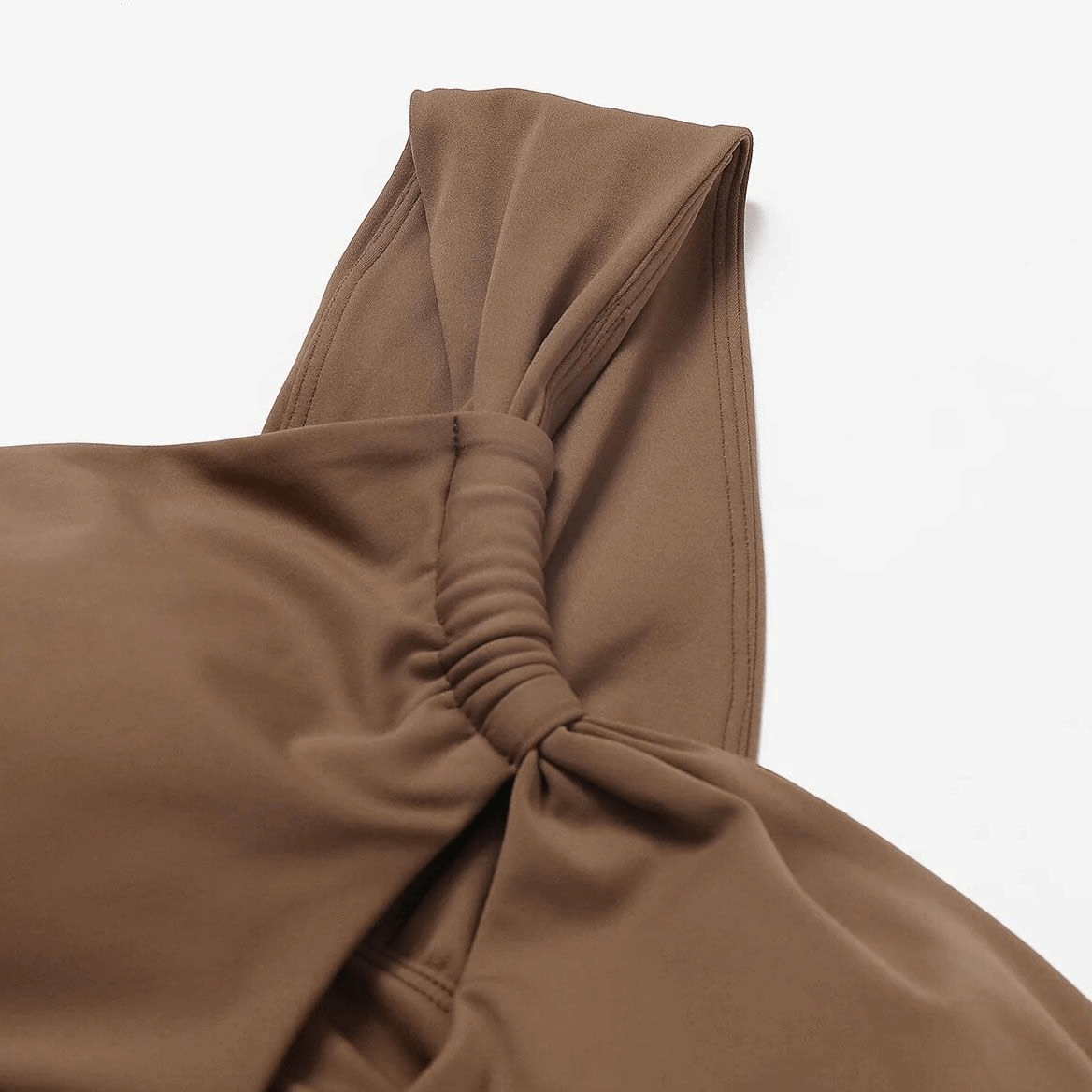 Close-up of brown one shoulder backless fitness yoga sports bra made of breathable Nylon and Spandex with adjustable strap.