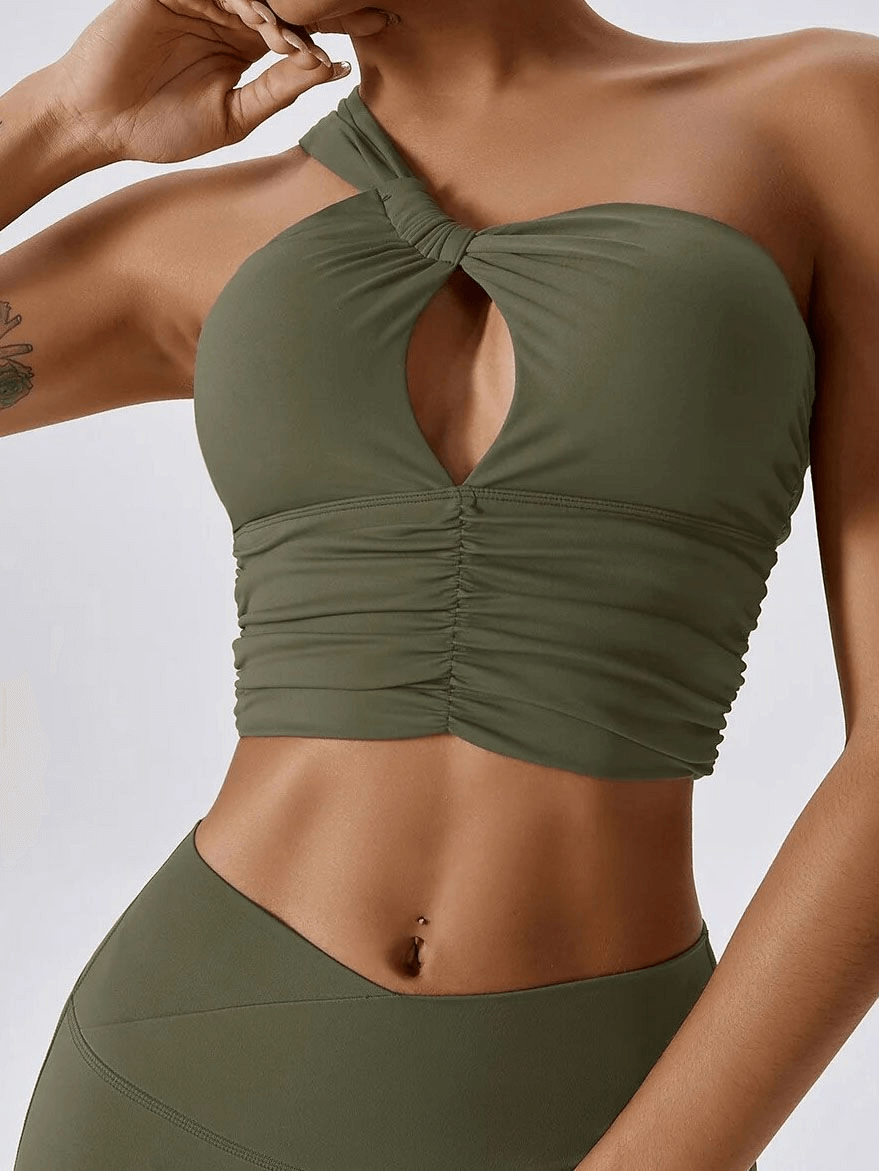 One Shoulder Backless Fitness Yoga Sports Bra in green, ideal for female athletes. Made of breathable Nylon and Spandex for comfort and support.