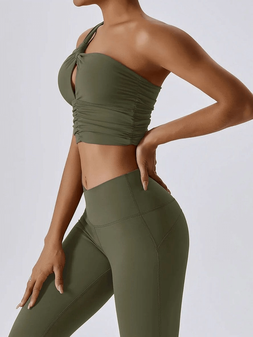 One shoulder backless yoga sports bra in olive green, perfect for female athletes. Comfortable, breathable nylon-spandex blend.