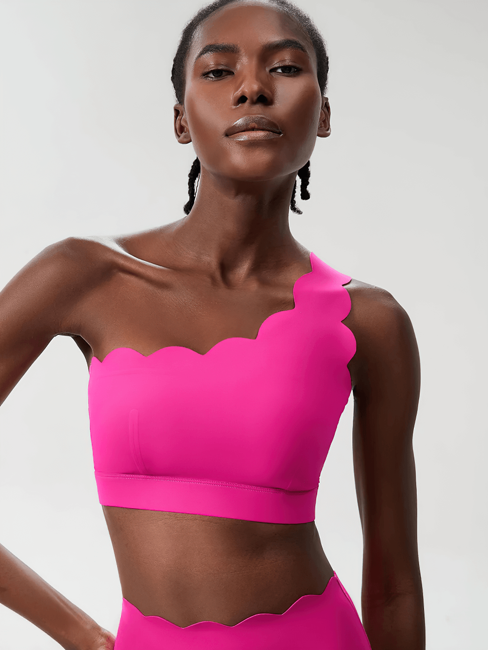 Model wearing One-Shoulder Scallop Seamless Yoga Sports Bra - SF4012 in vibrant pink with scalloped edges, perfect for yoga and Pilates.