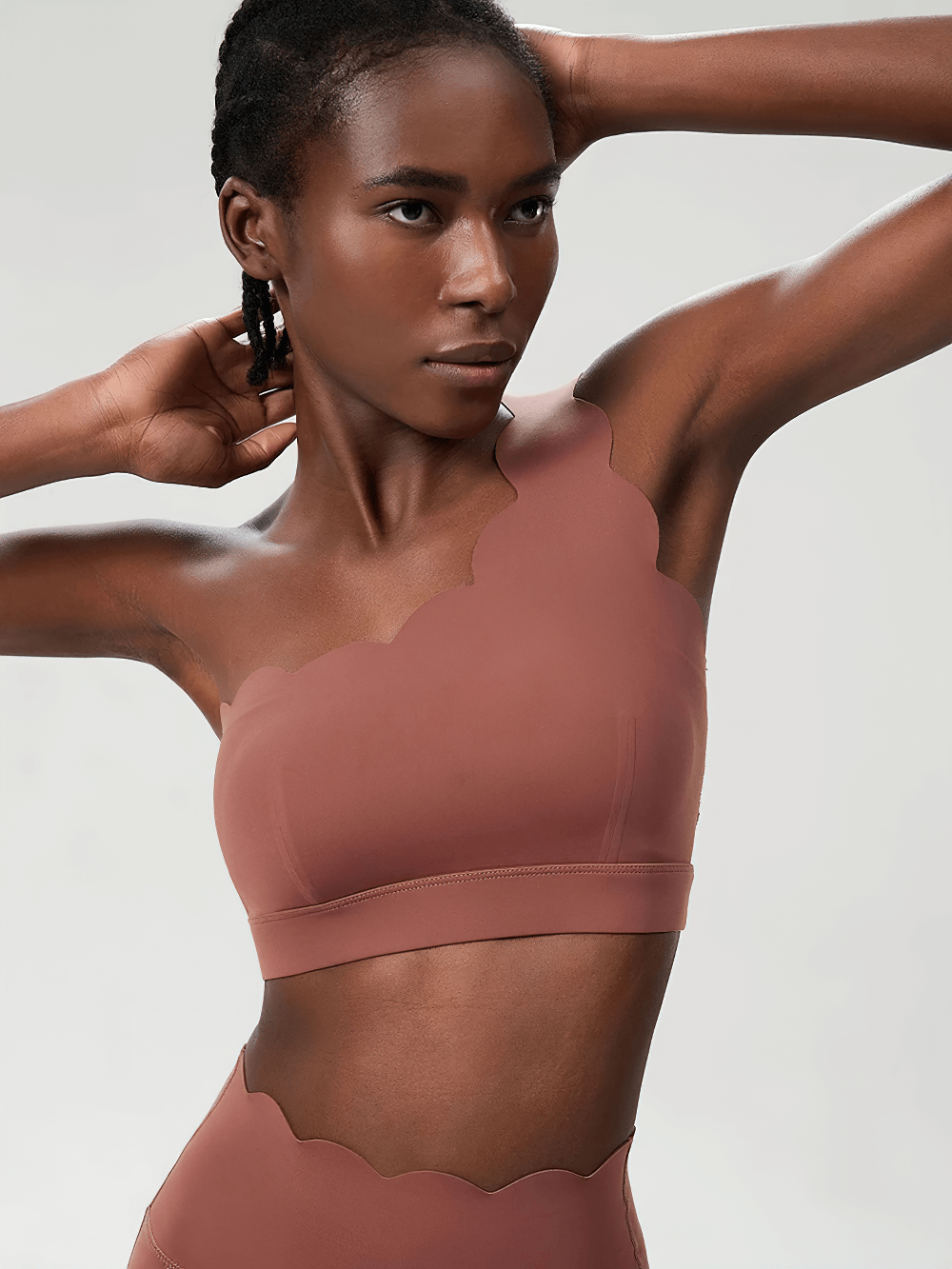 Model wearing One-Shoulder Scallop Seamless Yoga Sports Bra - SF4012 with scalloped edge and asymmetrical strap, perfect for yoga.