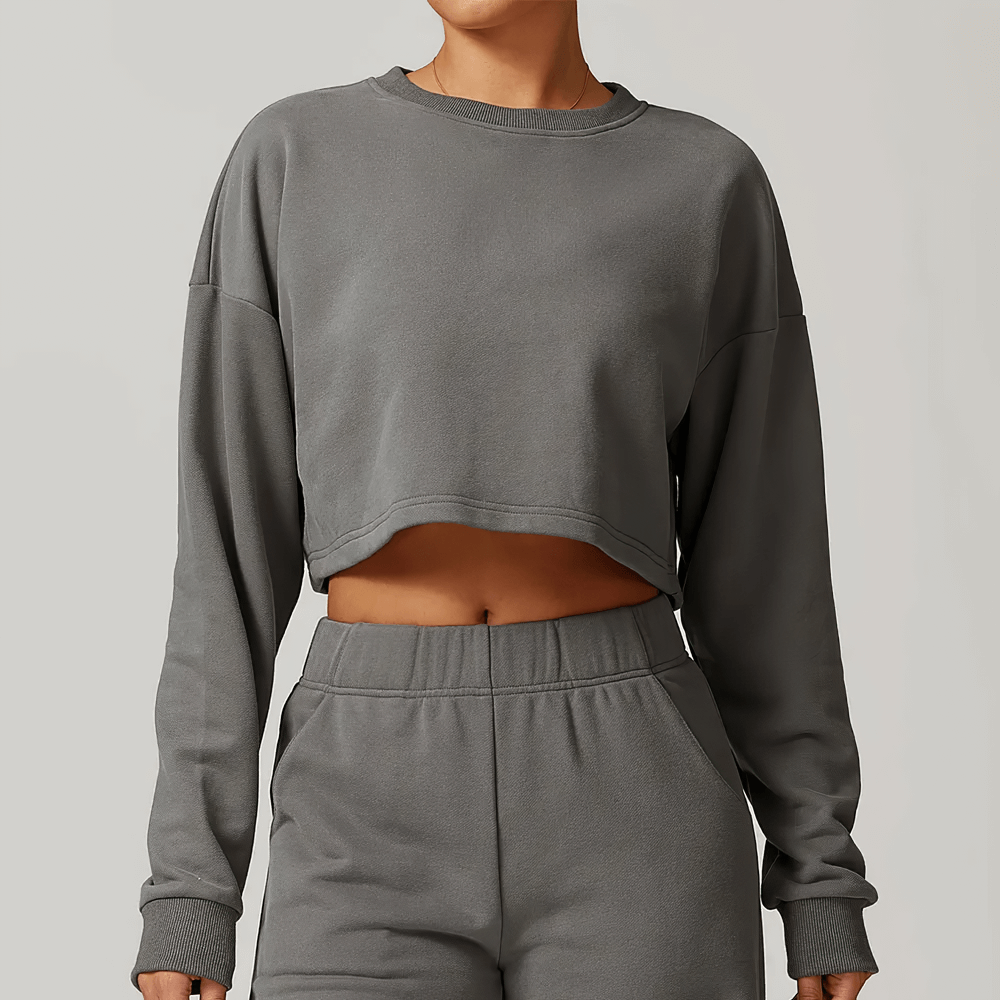 Woman wearing open back long sleeve sweatshirt with relaxed fit for active lifestyle