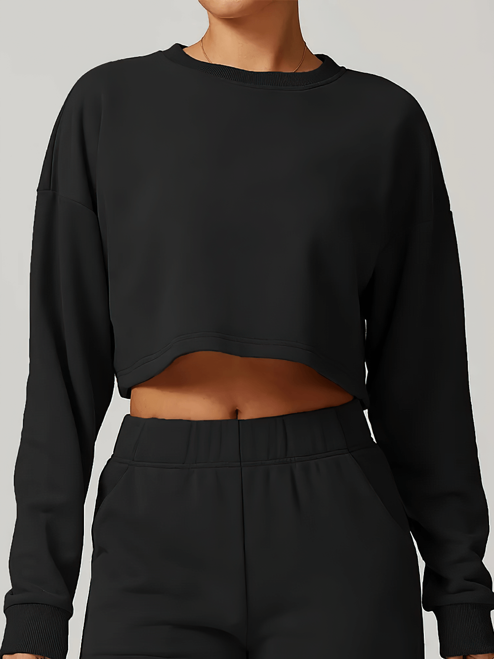 Woman wearing open back long sleeve round neck sweatshirt with pockets, perfect for running and activewear. Anti-wrinkle, loose fit.