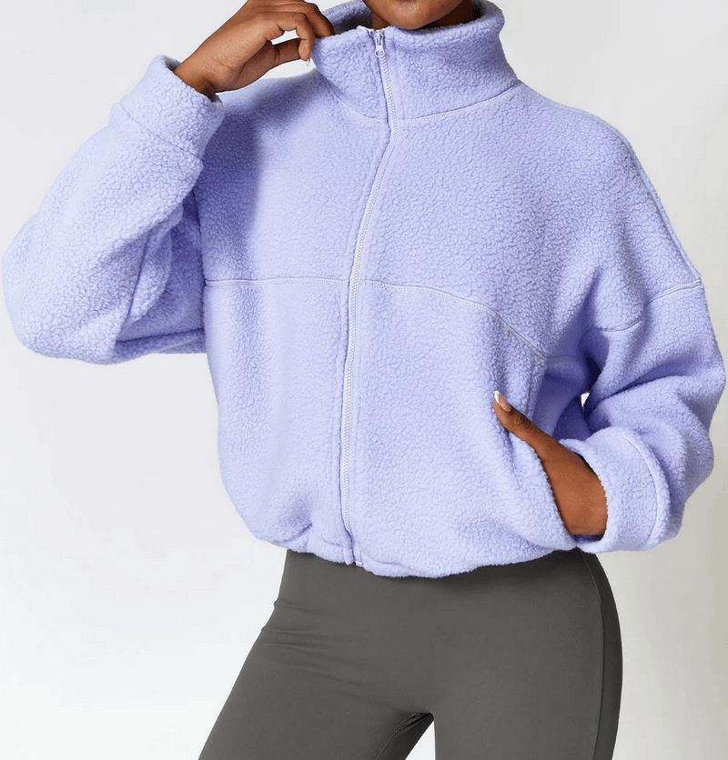 Woman wearing a lavender outdoor long sleeves zipper sports fleece jacket, ideal for yoga and outdoor activities.