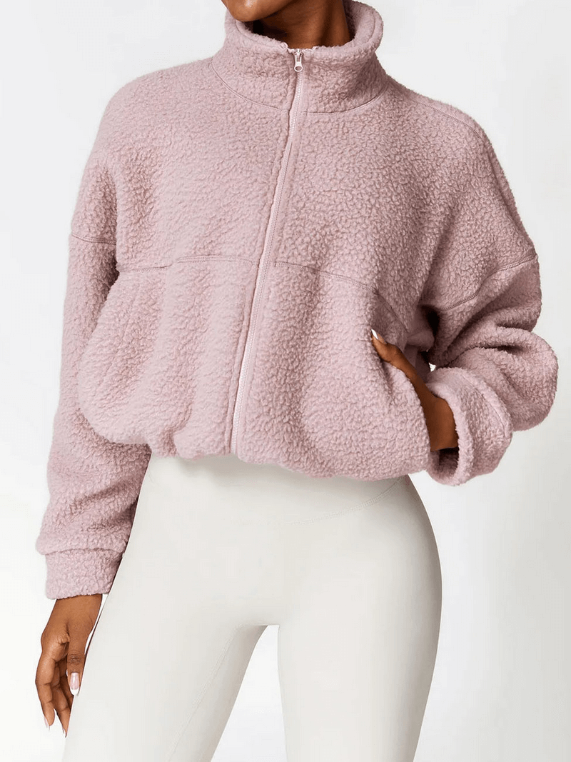 Woman wearing pink Outdoor Long Sleeves Zipper Sports Fleece Jacket, ideal for yoga and outdoor activities, premium nylon and spandex.