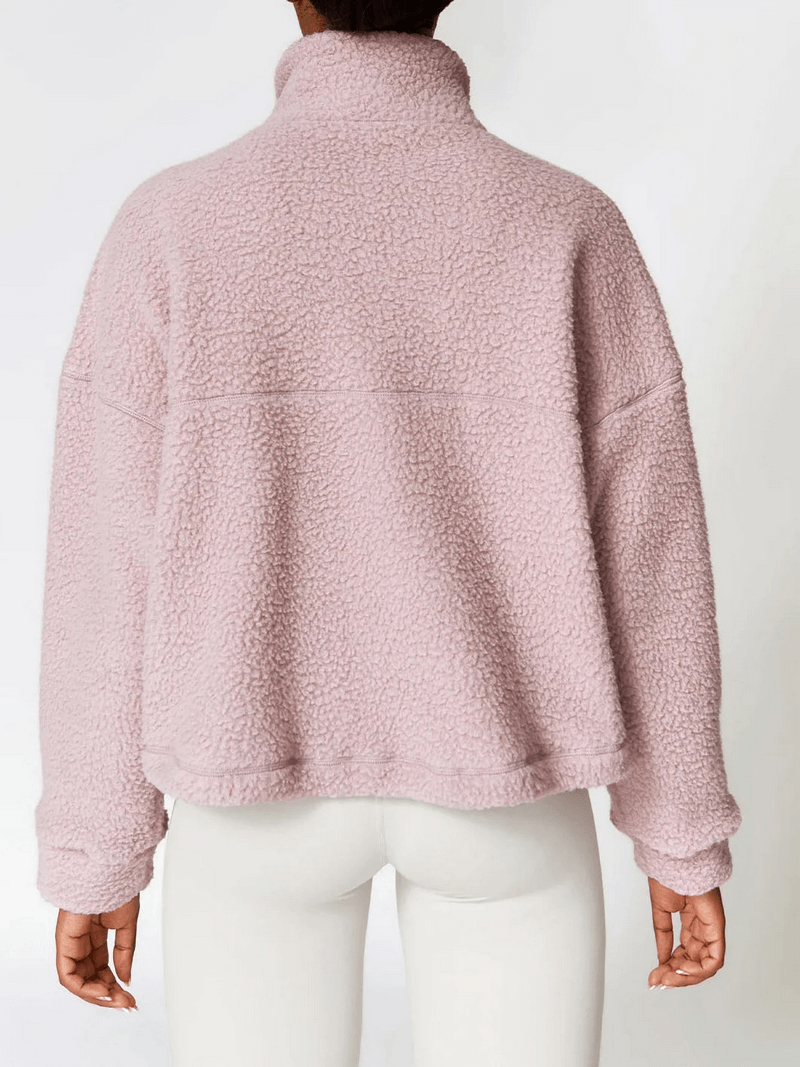 Back view of a pink fleece jacket, perfect for outdoor activities, showcasing the full sleeves and comfortable fit.