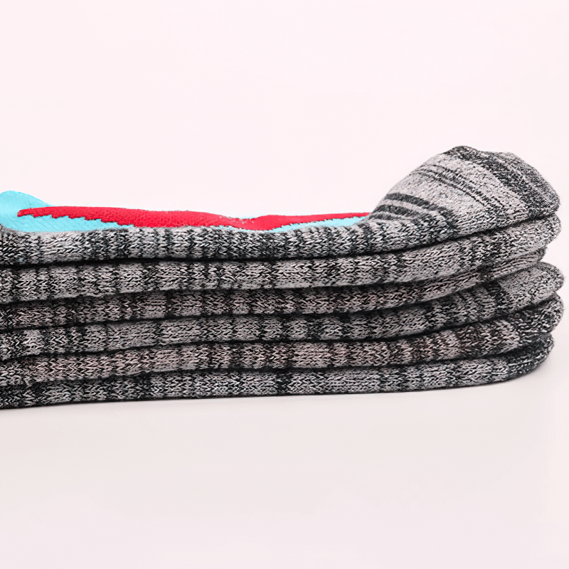 Cozy, thickened hiking and skiing socks stacked neatly, showcasing their breathable, anti-friction material for outdoor warmth and comfort.