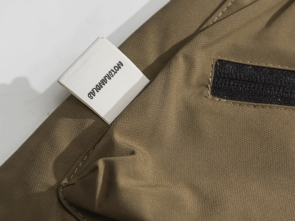 Close-up of a tactical utility vest pocket with durable stitching, showcasing the lightweight polyester fabric and secure zipper.