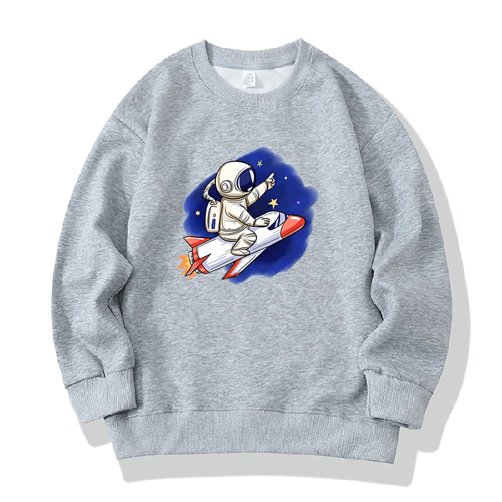 Kids graphic sweatshirt with astronaut riding a rocket, surrounded by stars. Perfect for space enthusiasts. Available in multiple colors.