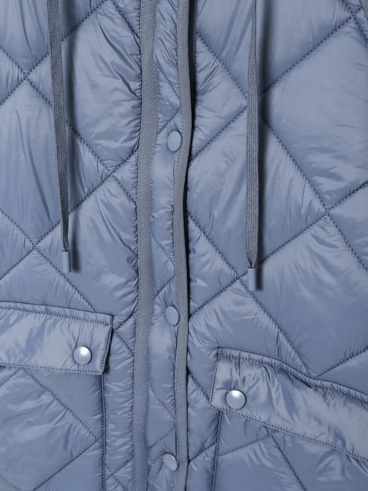 Quilted oversize coat with long sleeves, button closure, and pockets in gray, perfect for winter warmth and style.