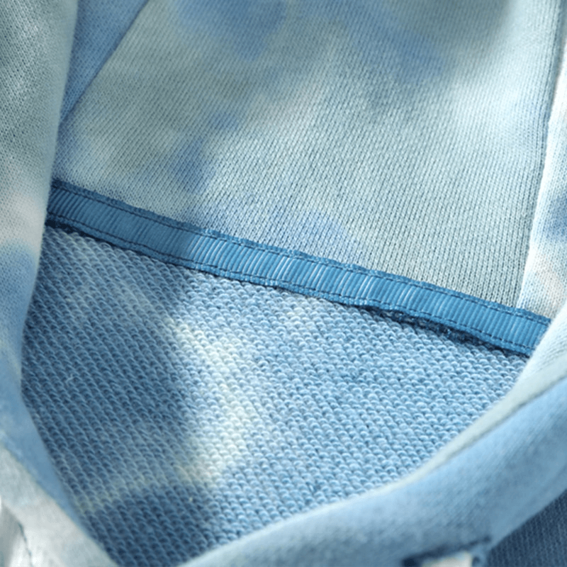 Close-up of blue oversized cotton hoodie with printed design, showcasing breathable fabric texture. Perfect for a relaxed, stylish look.