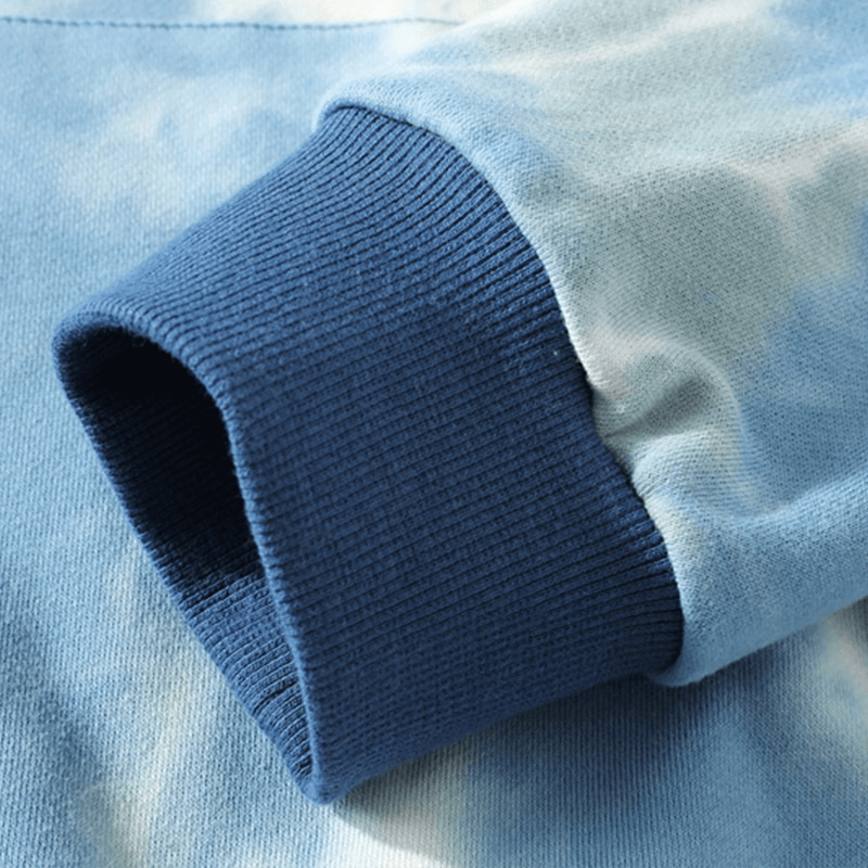 Close-up of blue ribbed cuff on oversized cotton hoodie with print, showcasing detailed texture and high-quality fabric.