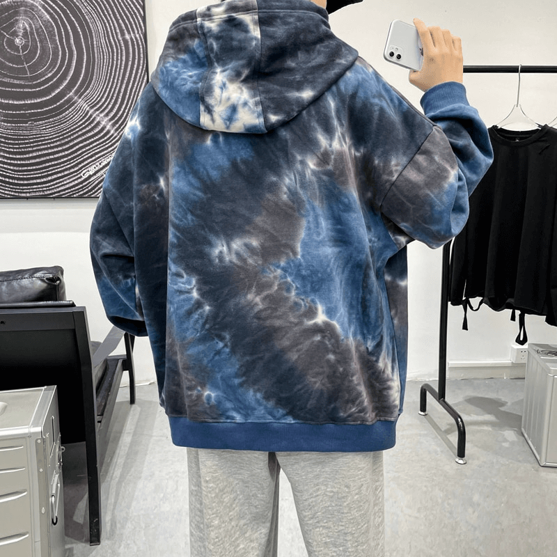 Model wearing oversized cotton hoodie with artistic print, showcasing a relaxed fit ideal for casual menswear fashion.