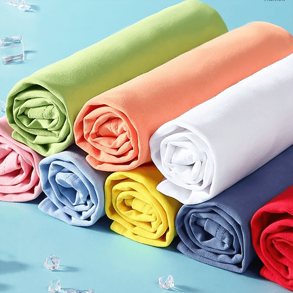 Colorful rolled cotton fabric bundles in various shades on a light blue background.