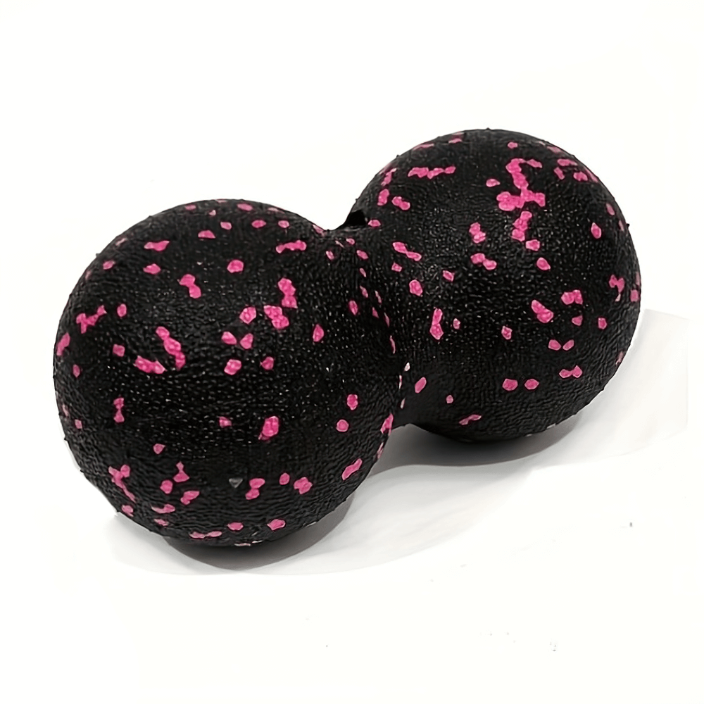 Peanut-shaped high-density lacrosse massage ball with pink and black design for deep tissue therapy and muscle relief.