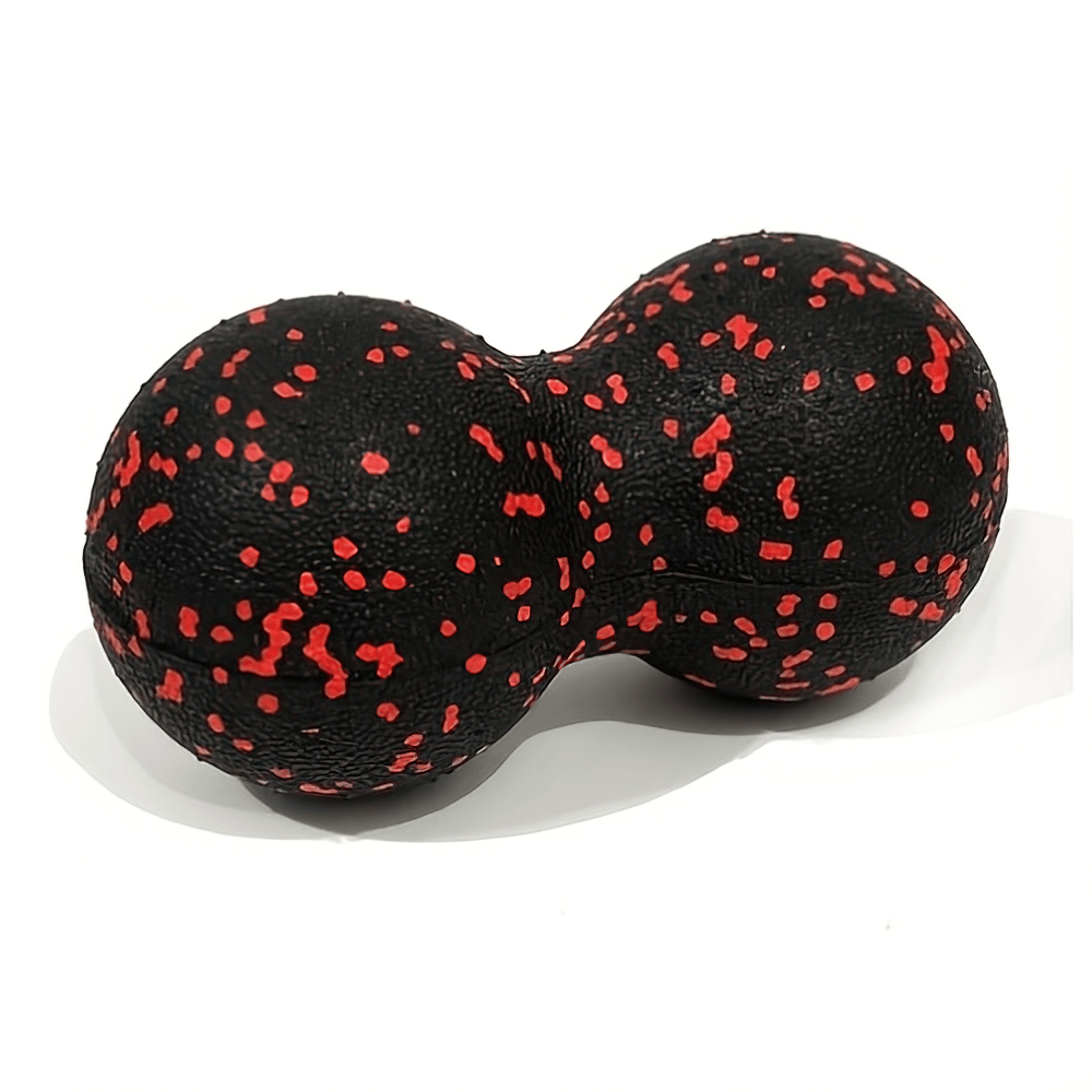 Peanut-shaped high-density massage ball for muscle relief and deep tissue therapy in black with red speckles.