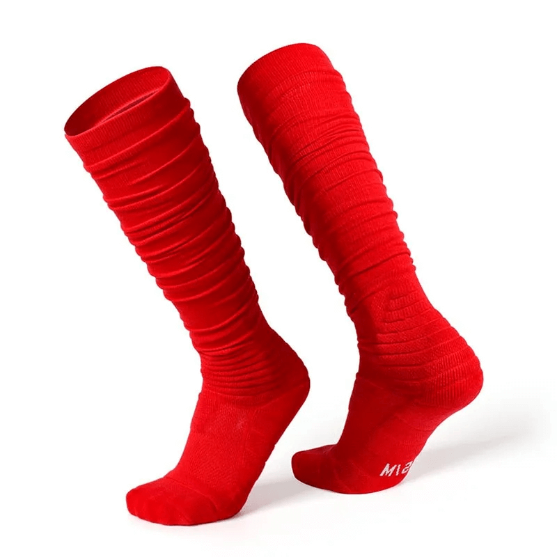 Bright red knee-high rugby socks with ribbed design, designed for durability and comfort. Ideal for athletes seeking performance and style.