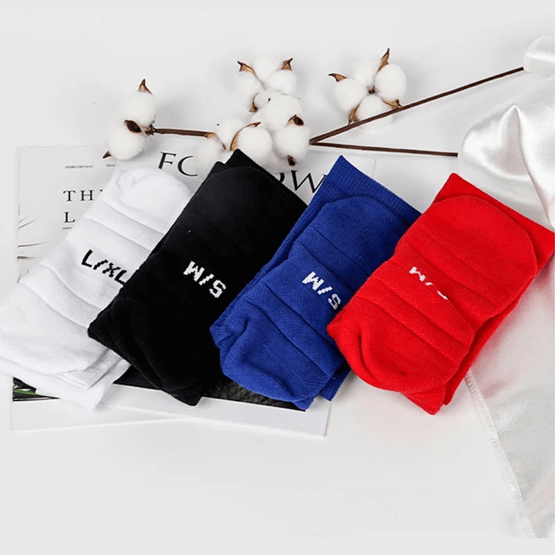 Colorful knee-high rugby socks in white, black, blue, and red, displayed with cotton stems for a stylish and athletic look.