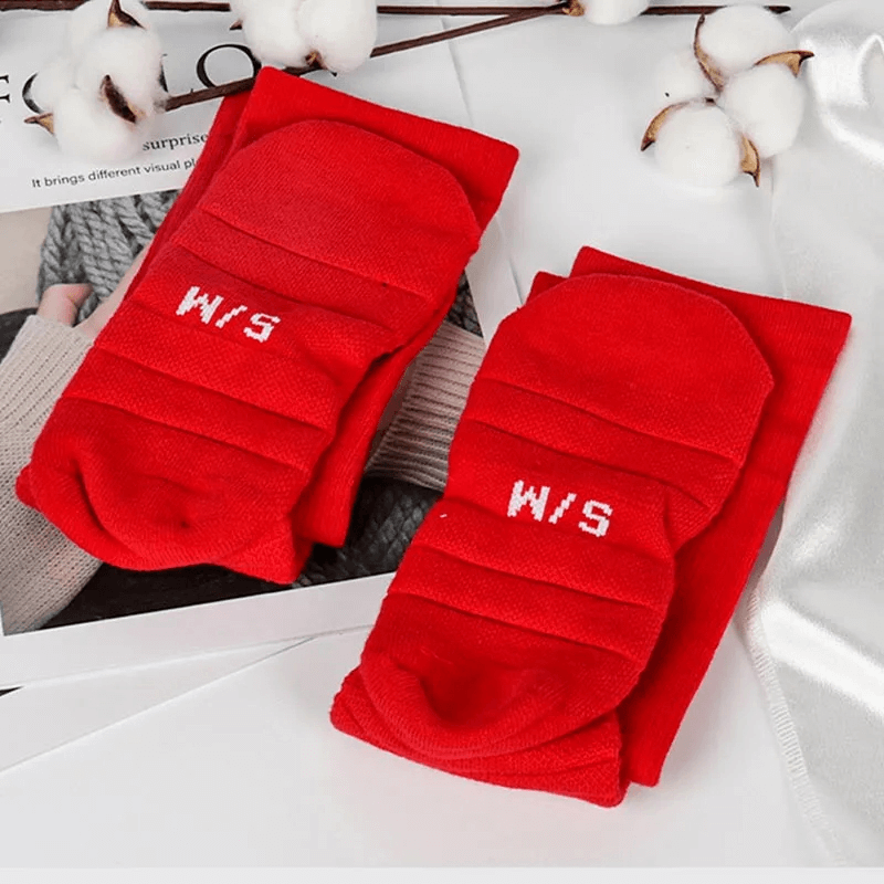 Red ribbed compression knee-high socks on white background with cotton accents, ideal for sports performance and durability.