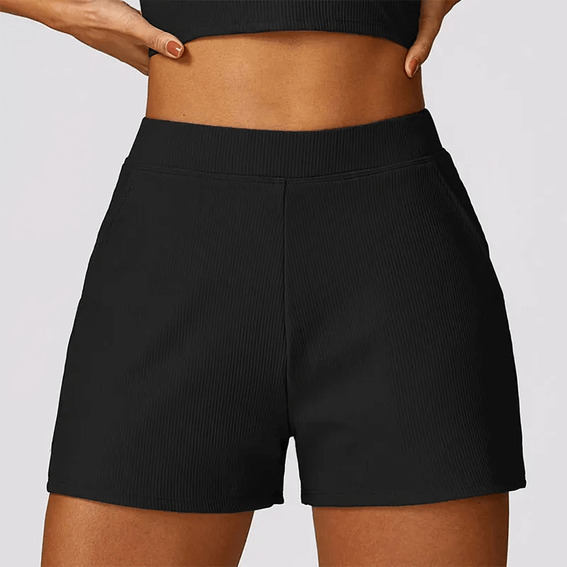 Gray high waist workout shorts for women with ribbed waistband and side pockets, ideal for yoga and gym sessions.