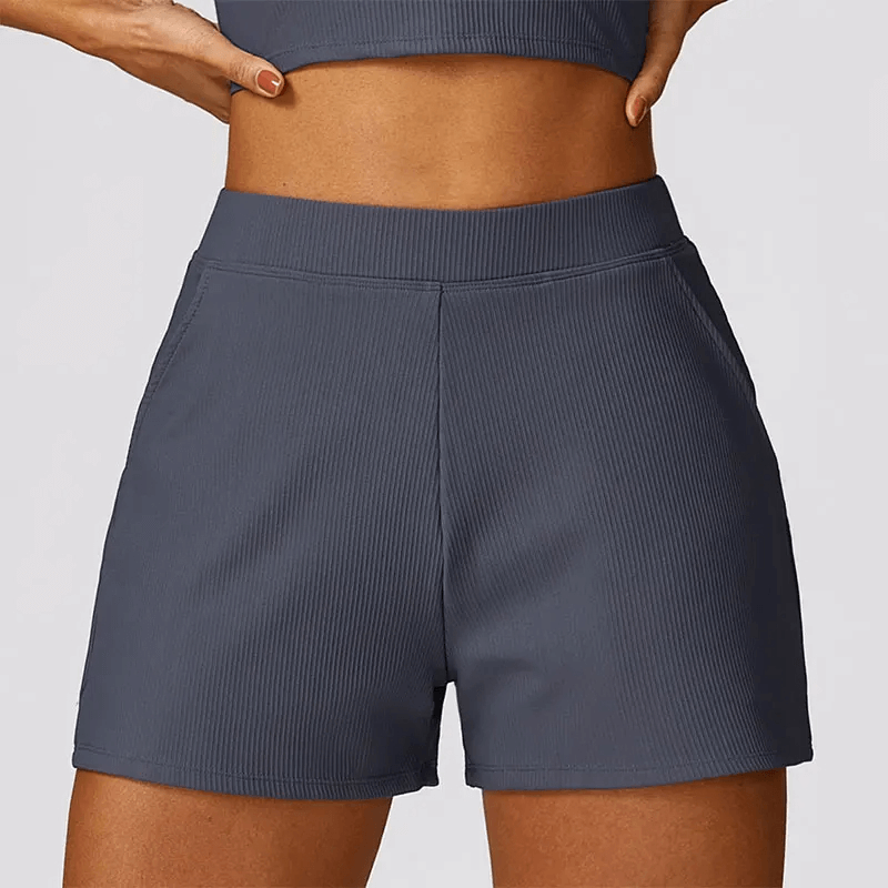 Gray high waist workout shorts for women with ribbed waistband and side pockets, perfect for running, gym, and yoga.